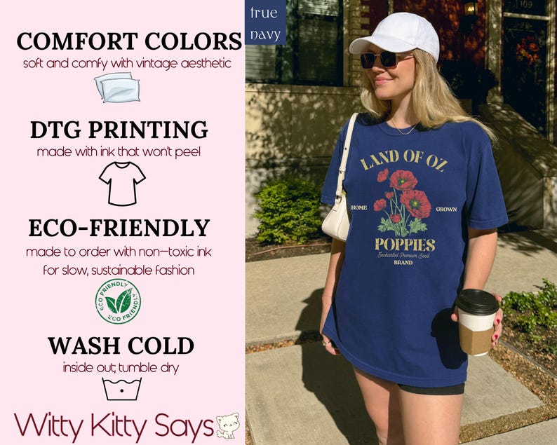 May include: Navy blue t-shirt with a graphic of red poppies and the text "LAND OF OZ POPPIES". The shirt also has the text "HOME" and "GROWN". The shirt is part of the "Witty Kitty Says" brand.