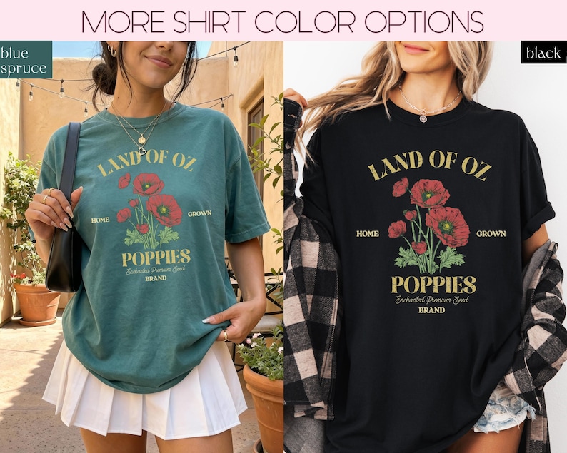 May include: Two t-shirts, one blue-green and one black, each with a graphic featuring the text "LAND OF OZ" above a floral illustration of red poppies. Below the flowers, the word "POPPIES" is displayed. The shirts are short-sleeved.