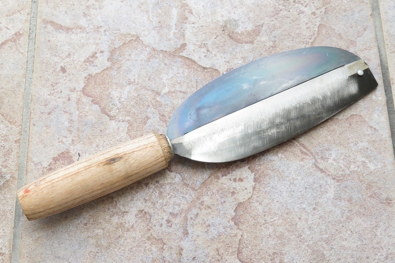 May include: A wooden handled metal knife with a curved blade. The blade is dull and has a slight blue tint.