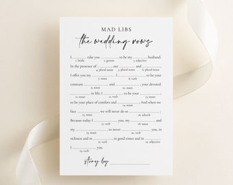 May include: A printable Mad Libs game titled "The Wedding Vows". The game is designed for a wedding and includes fill-in-the-blank spaces for words like "bride", "groom", "adjective", and "noun".
