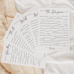 5 Wedding Mad Libs Games laying on soft, gauze fabric