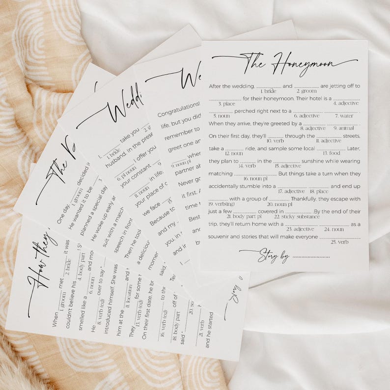 5 Wedding Mad Libs Games laying on soft, gauze fabric