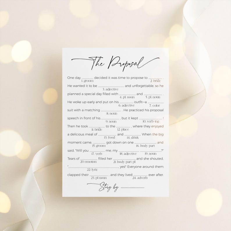 "the proposal" mad libs game laying on neutral background with a silk ribbon under the card