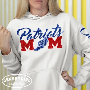 May include: White hoodie with blue and red glitter text that says "Patriots Mom" with a blue glitter running shoe graphic.