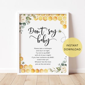 May include: A printable sign for a baby shower game, with a honeycomb pattern and floral accents. The sign says "Don't Say Baby" and includes instructions for the game.