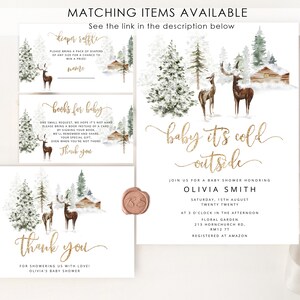 May include: A baby shower invitation with a winter woodland theme. The invitation features a watercolor illustration of a snowy forest with deer and a cabin. The text reads "baby it's cold outside" in gold glitter lettering. The invitation is for Olivia Smith's baby shower on Saturday, August 15th at 3 o'clock in the afternoon at Floral Garden, 213 Hornchurch Rd, RM12 7T. The invitation is registered at Amazon.