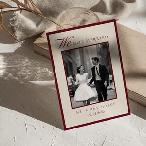 May include: A wedding announcement card with a claret border and the words "We Got Married" in elegant script. The card features a black and white photo of a couple and the text "Mr. & Mrs. Hodge 12.25.2029".