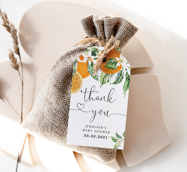 May include: A white thank you tag with orange blossoms and fruit, with the text "thank you" and "Jennifer's Baby Shower 05.05.2021".