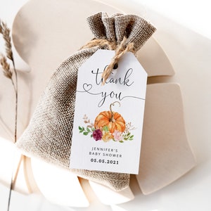 May include: A white thank you tag with a watercolor pumpkin and floral design. The tag says "Thank you" with a heart and "Jennifer's Baby Shower 05.05.2021".