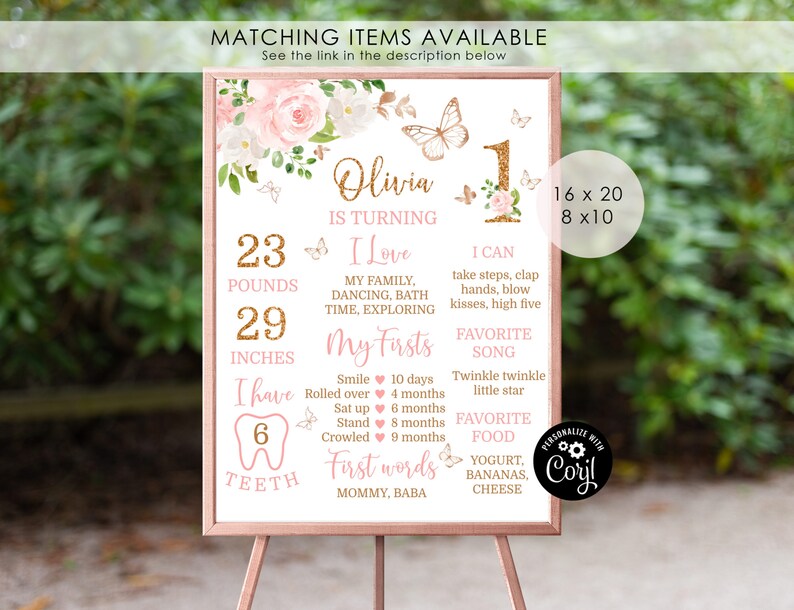 May include: A pink and gold first birthday milestone poster with a floral design and butterflies. The poster includes the child's name, Olivia, and details about their first year, including weight, height, milestones, favorite song, and favorite food.