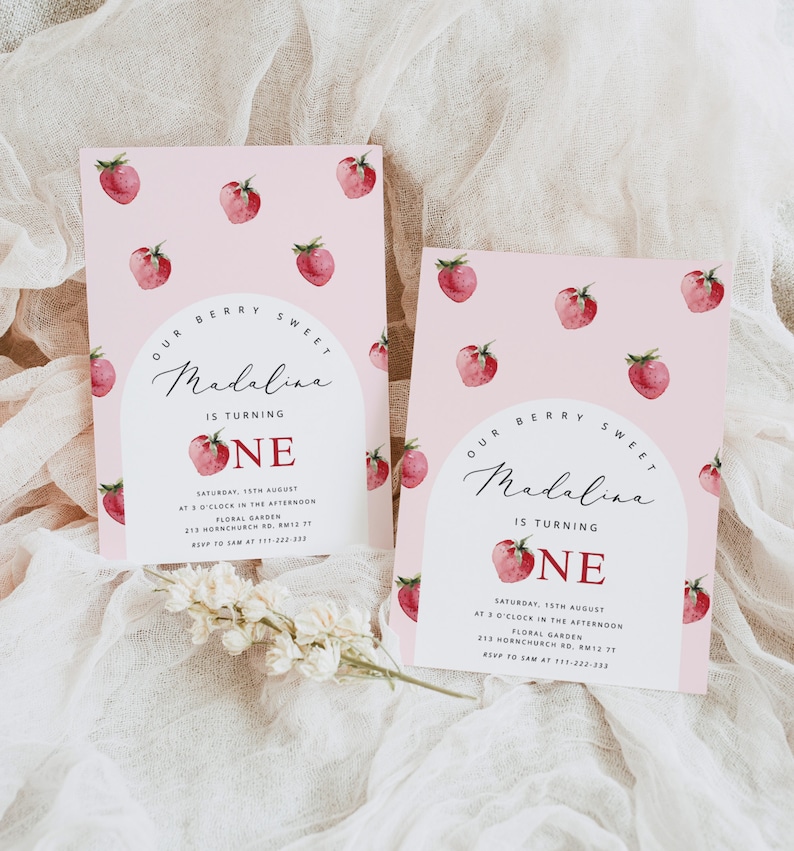 May include: Pink invitation with a red strawberry pattern. The invitation says "Our Berry Sweet Madalina is turning One" with a red strawberry graphic. The invitation includes the date, time, location, and RSVP information.
