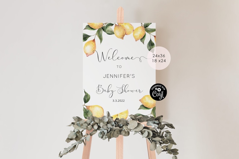 May include: A white welcome sign with a lemon theme. The sign reads "Welcome to Jennifer's Baby Shower 3.3.2022".