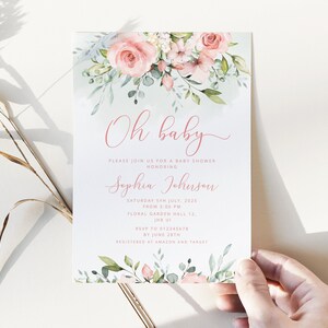 May include: A baby shower invitation with a watercolor floral design in shades of pink and green. The text reads "Oh baby" and includes the name "Sophia Johnson", the date "Saturday 5th July, 2025", the time "from 3:00 PM", the location "Floral Garden Hall 12, JHB 01", the RSVP information "RSVP to 012345678 by June 28th", and the registry information "Registered at Amazon and Target".
