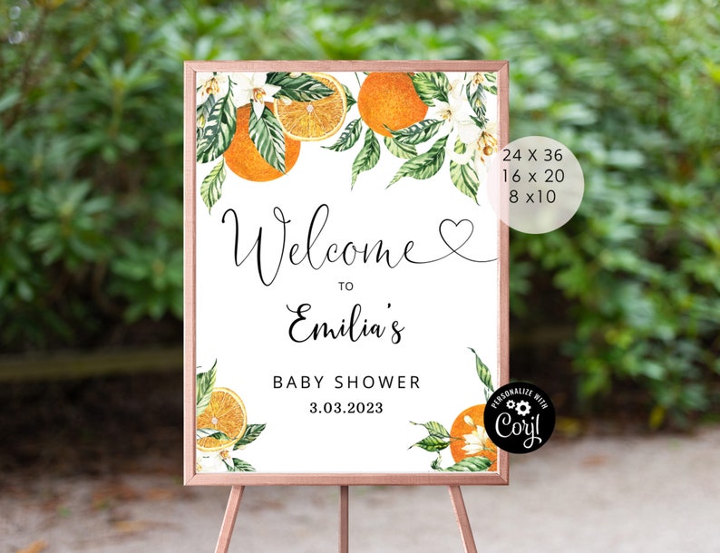 May include: A welcome sign for a baby shower with a watercolour illustration of orange blossoms and oranges. The sign says "Welcome to Emilia's Baby Shower 3.03.2023".