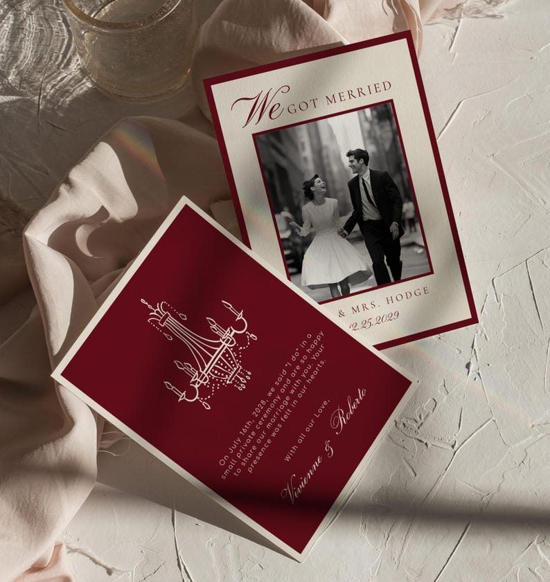 May include: Burgundy and cream wedding invitations. One card features a black and white photo of a couple, the text "We Got Married," and the date. The other card has a chandelier design and text.
