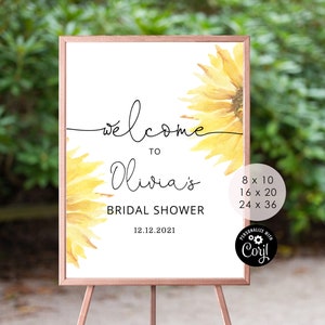 May include: A printable welcome sign for a bridal shower with a sunflower design. The sign says "Welcome to Olivia's Bridal Shower 12.12.2021".