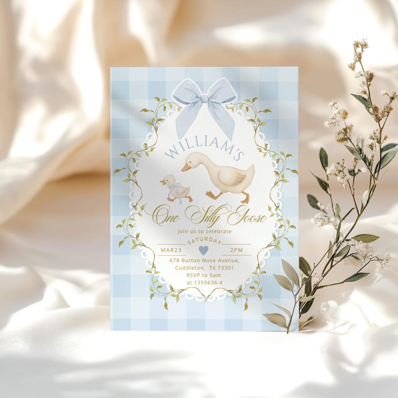 May include: A light blue invitation card with a gingham pattern background. The card features a watercolor illustration of a goose and gosling, with the text "WILLIAM'S One Silly Goose". Additional text includes the date, time, and RSVP information.