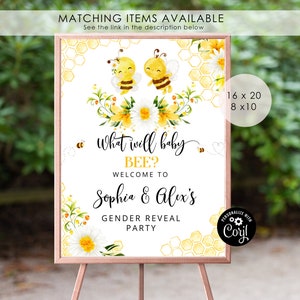 May include: A gender reveal party sign with a yellow and white honeycomb pattern, two cartoon bees, and the text "What will baby BEE? Welcome to Sophia & Alex's Gender Reveal Party".