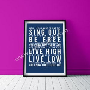 May include: A blue poster with white text that reads "WELL, IF YOU WANT TO SING OUT SING OUT AND IF YOU WANT TO BE FREE BE FREE 'CAUSE THERE'S A MILLION THINGS TO BE YOU KNOW THAT THERE ARE AND IF YOU WANT TO LIVE HIGH LIVE HIGH AND IF YOU WANT TO LIVE LOW LIVE LOW 'CAUSE THERE'S A MILLION WAYS TO GO YOU KNOW THAT THERE ARE"