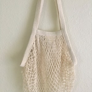 natural color french market bag hanging on a white wall