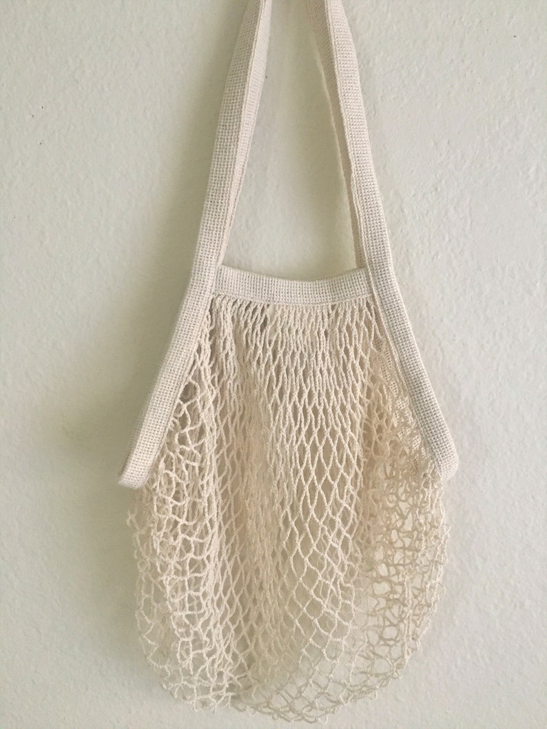 natural color french market bag hanging on a white wall
