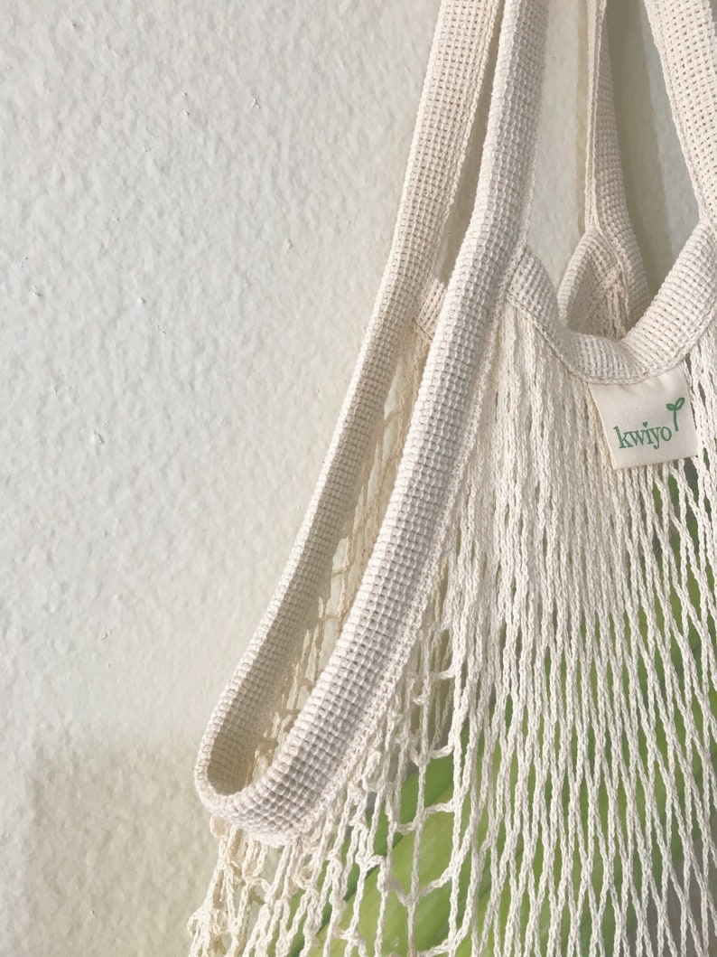 close up image of a cotton french market bag showing sides and straps