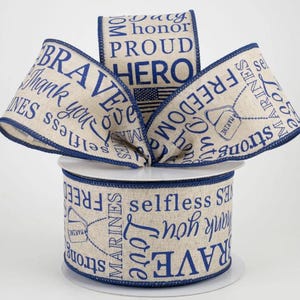 May include: A roll of beige ribbon with navy blue text and trim. The ribbon features patriotic words like "Brave," "Freedom," and "Hero," along with an American flag and military dog tag graphic. Perfect for crafting or gift wrapping.