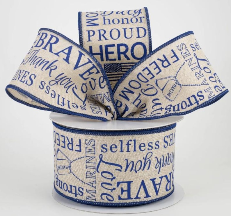 May include: A roll of beige ribbon with navy blue text and trim. The ribbon features patriotic words like "Brave," "Freedom," and "Hero," along with an American flag and military dog tag graphic. Perfect for crafting or gift wrapping.