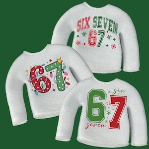 May include: Three white sweaters with the number "67" in red and green, with the words "six" and "seven" in various designs. One sweater has the words "six seven" above the number. The sweaters have a Christmas theme.