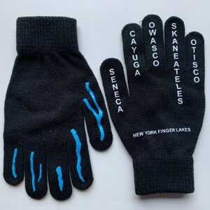May include: Black knit gloves with blue fingertip designs and white text on the back of the right glove that reads "Cayuga, Seneca, Wasco, Owasco, Skaneateles, Otisco" and "New York Finger Lakes".