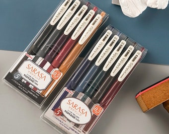 May include: Two packs of Zebra Sarasa Vintage gel pens in clear plastic packaging. Each pack contains five pens in various colors, with the text "SARASA" and "VINTAGE Color" visible. The pen tips are 0.5 mm.
