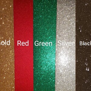 May include: Five vertical strips of glitter paper in gold, red, green, silver, and black.
