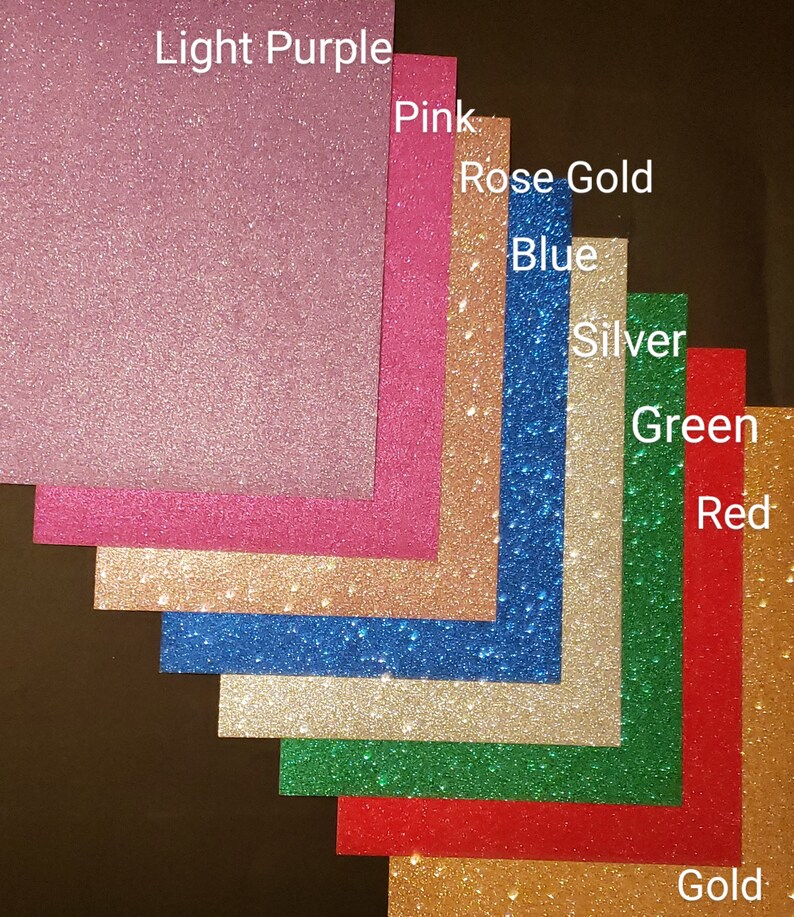May include: A variety of glitter paper samples in different colors, including light purple, pink, rose gold, blue, silver, green, red, and gold.