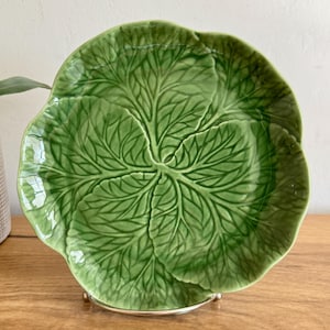 May include: A white ceramic mug with a black handle and the text "But First, Coffee" in a black, bold font. The mug is sitting on a white surface. The mug appears to be 12 ounces.