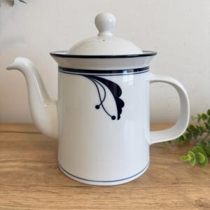 May include: A set of three ceramic mugs with a speckled, matte finish. The mugs are in shades of cream, light gray, and dark gray. Each mug has a simple, minimalist design and a rounded handle. Perfect for coffee or tea.