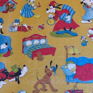 May include: A repeating pattern featuring Disney characters in various sleeping scenes. Donald Duck, Goofy, Pluto, and Huey, Dewey, and Louie are depicted in pajamas and nightcaps on a yellow background. A red bed, a lamp, and a toy fire truck are also visible.