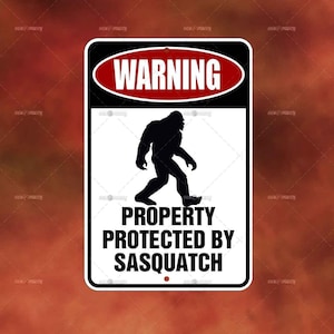 May include: A black and white warning sign with a red oval that says "WARNING" in white letters. The sign features a silhouette of a Sasquatch walking. The text below the image says "PROPERTY PROTECTED BY SASQUATCH".