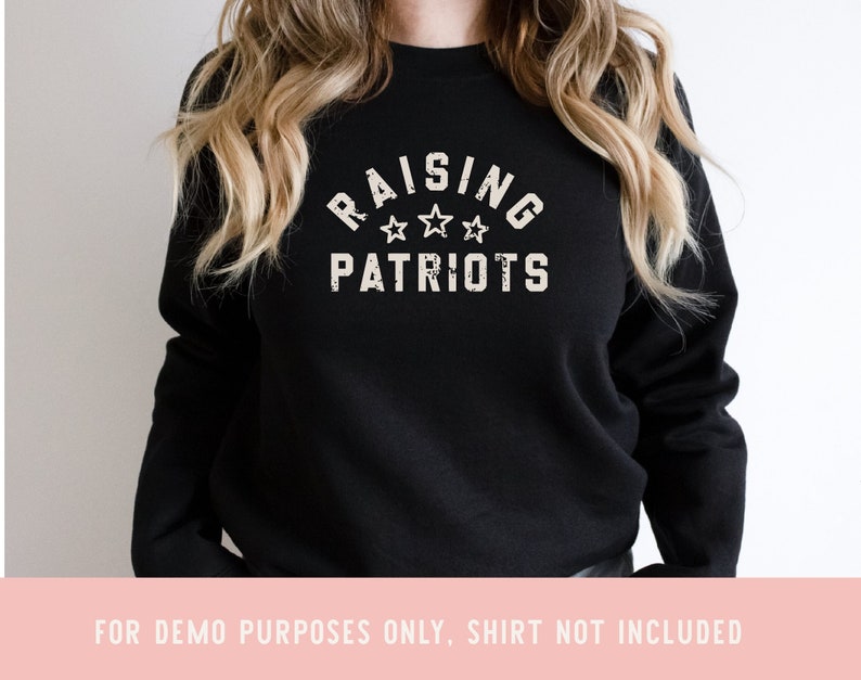 May include: Black sweatshirt with the text "Raising Patriots" in white with three stars above the word "Patriots".