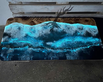 May include: A dark blue and white epoxy resin table top with a wave pattern. The table top is made of wood and has a natural wood grain.