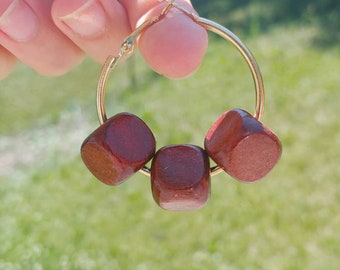 Beautiful gold hoop earrings with natural red wood beads