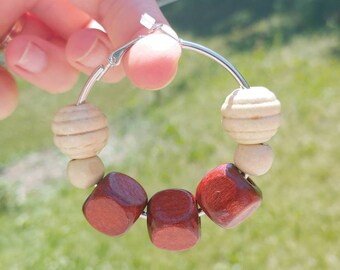 Beautiful silver hoop earrings with natural red wood and two-tone beads