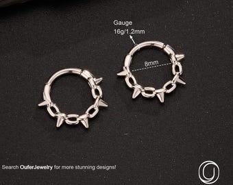 May include: Two silver hoop earrings with a spiked chain design. Each earring is 8mm in diameter and has a gauge of 16g/1.2mm. The text "Search OuferJewelry for more stunning designs!" is displayed.