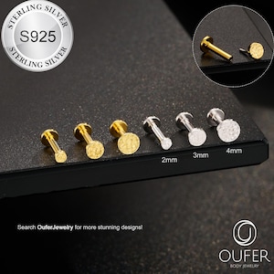 May include: A collection of sterling silver body jewelry, including labret studs and flat back earrings. The image shows various sizes, with some featuring textured designs. The text on the image reads "STERLING SILVER S925" and "OUFER BODY JEWELRY".