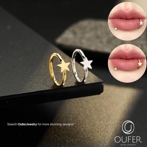May include: Two star-shaped body jewelry rings, one gold and one silver, are displayed. The rings are shown next to two close-up images of lips with star-shaped lip piercings. The text "Search OuferJewelry for more stunning designs!" is visible.