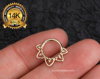 May include: Gold 14K flower-shaped clicker ring for body piercing. The ring has a beaded edge and five flower-shaped accents.