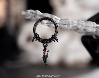 May include: Black 16 gauge, 8mm hoop with a black spike and red gem dangle. The hoop has a row of black spikes around the top.