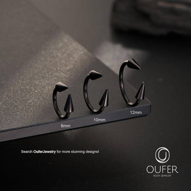 May include: Three black circular body jewelry rings with pointed spike ends, labeled with sizes 8mm, 10mm, and 12mm. The text "Search OuferJewelry for more stunning designs!" and the "OUFER BODY JEWELRY" logo are visible at the bottom of the image.