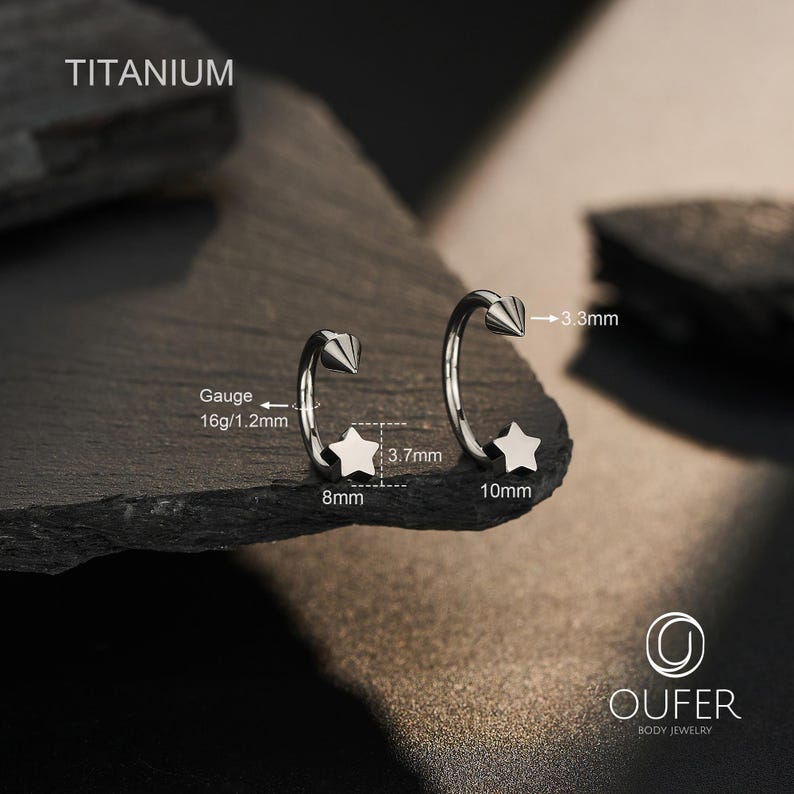 May include: Two titanium body jewelry pieces. Each piece has a star and a cone-shaped end. One star is 8mm, the other is 10mm. The gauge is 16g/1.2mm. The text "TITANIUM" is at the top. The brand logo "OUFER BODY JEWELRY" is at the bottom.