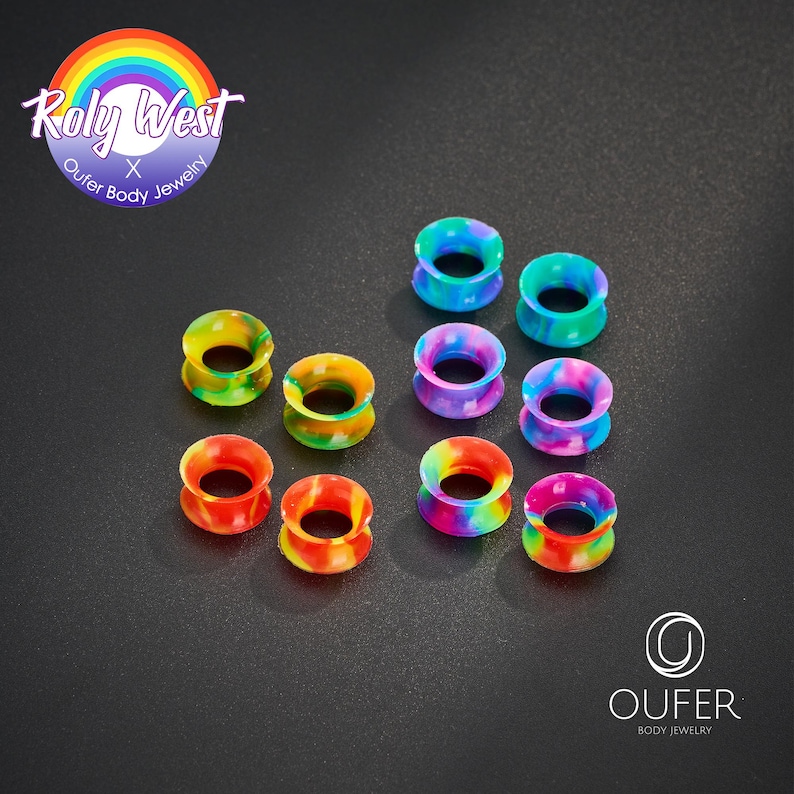 May include: A collection of colorful ear gauges in various rainbow patterns. The gauges are made of a soft material and are designed for stretched ear piercings. The image includes the text "Roly West Outer Body Jewelry" and "Oufer Body Jewelry".