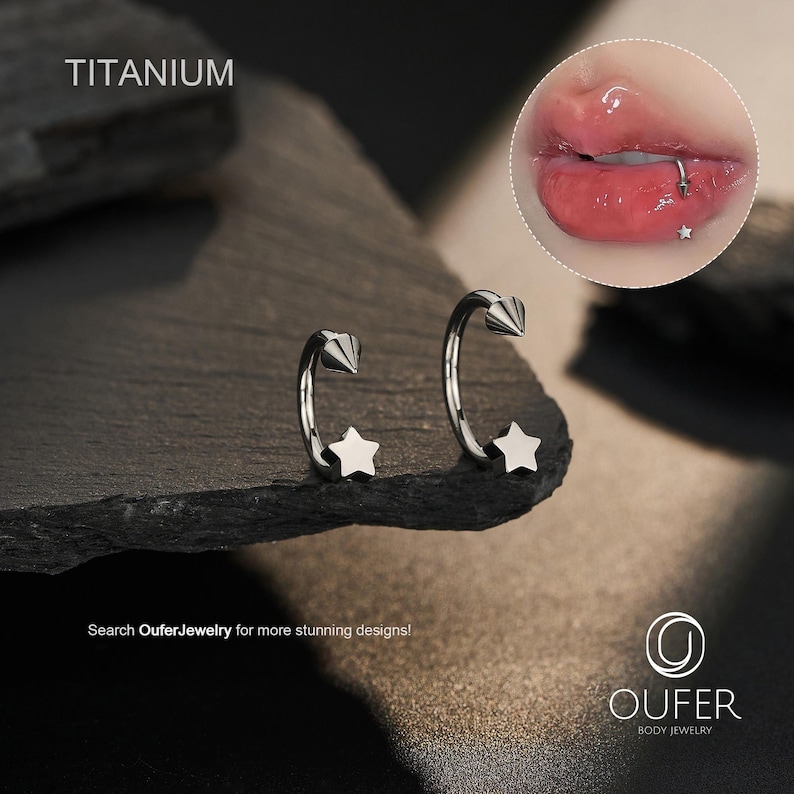 May include: Two silver-colored, curved barbell earrings with a star and cone design. The word "TITANIUM" is printed at the top left. The image also includes a close-up of a lip piercing with a star-shaped stud. The text "Search OuferJewelry for more stunning designs!" is at the bottom.